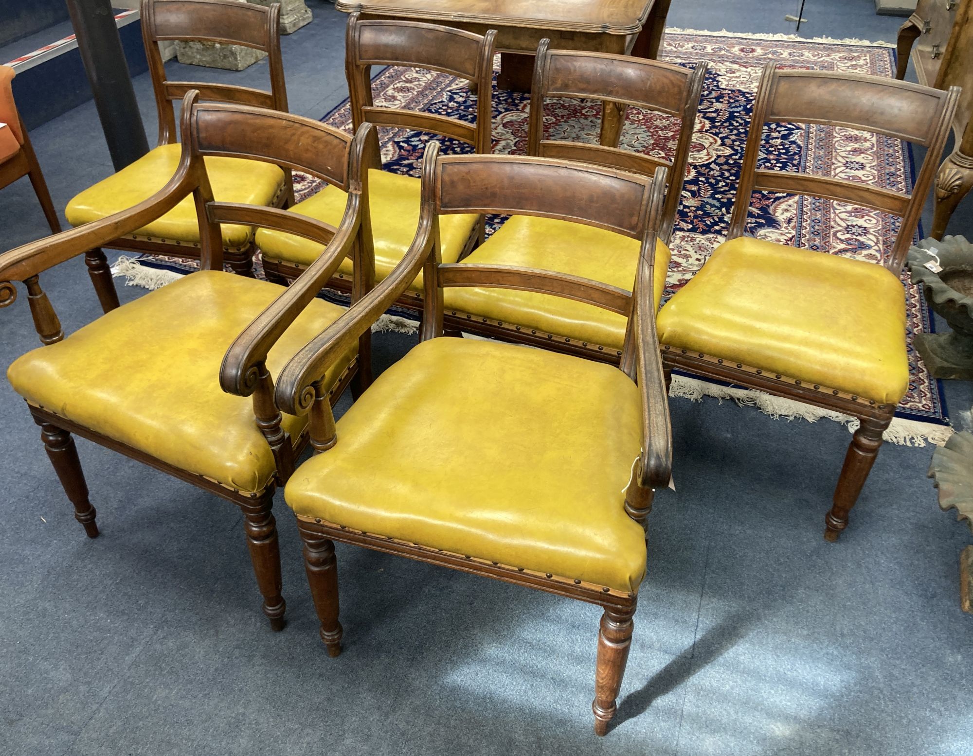 A set of six early Victorian mahogany dining chairs, two with arms