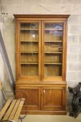 A late 19th century panelled oak library bookcase, length 118cm, depth 47cm, height 223cm