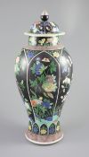 A Chinese famille noire enamelled biscuit baluster vase and cover, 19th century, decorated in Kangxi
