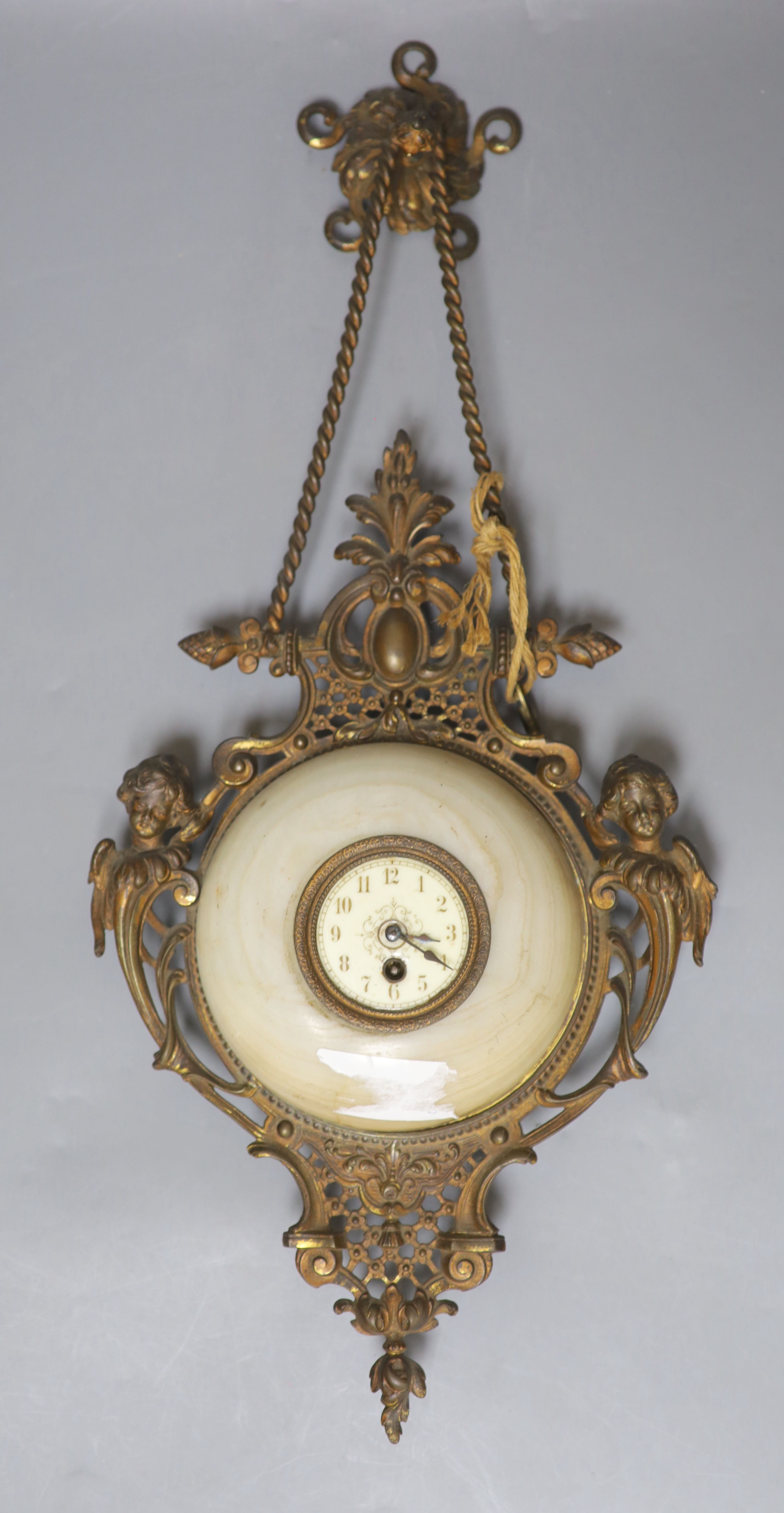 A French gilt metal, onyx and enamelled wall clock, length 49cm