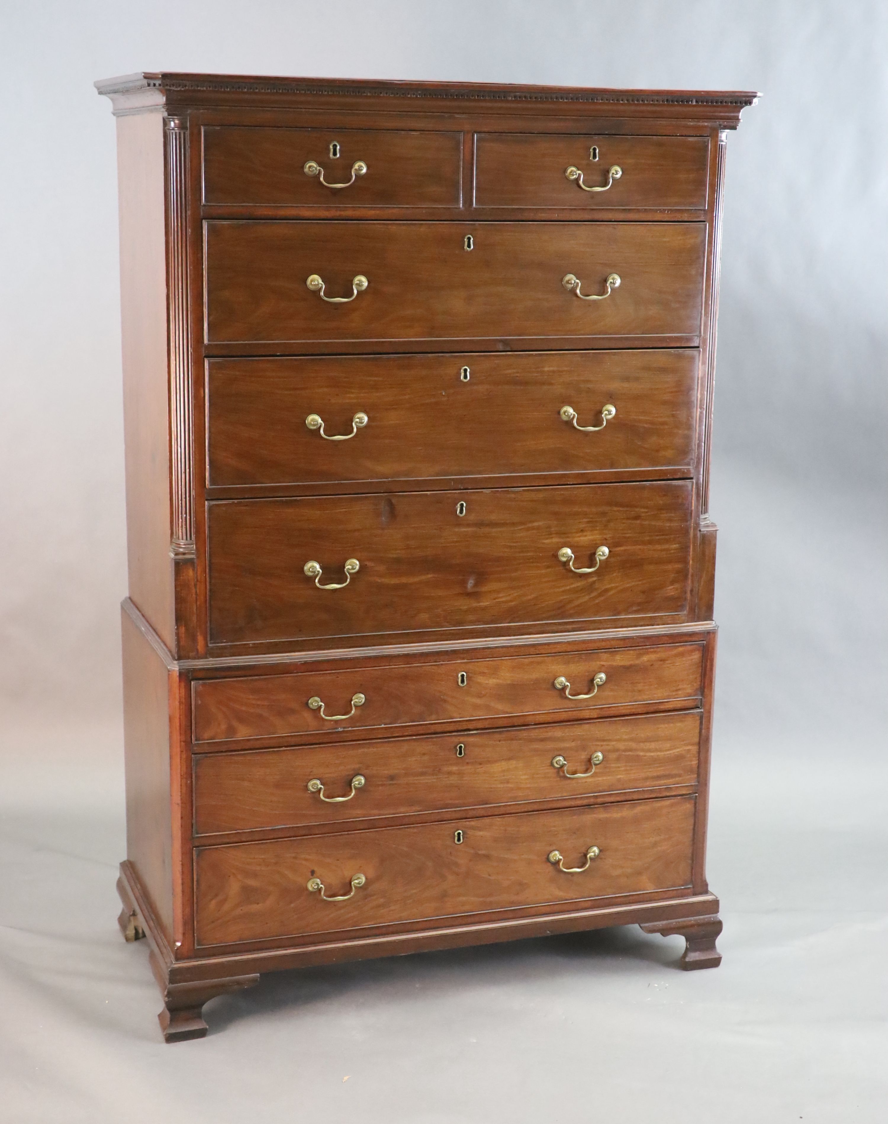 A George III mahogany chest on chest, with dentil cornice, two short and six graduated long drawers,