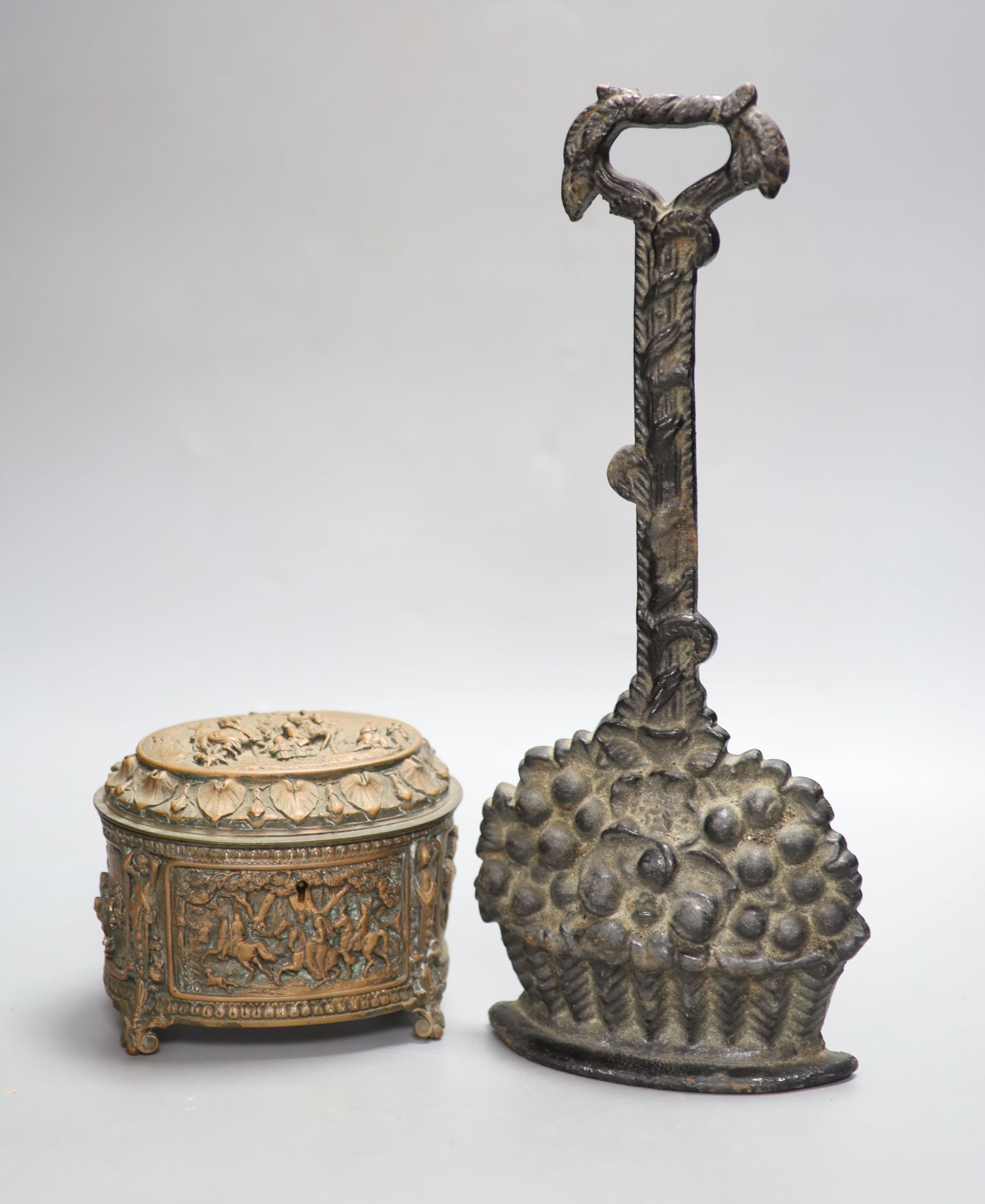 A Victorian black painted cast iron door stop, height 36cm, and a Victorian cast copper lidded