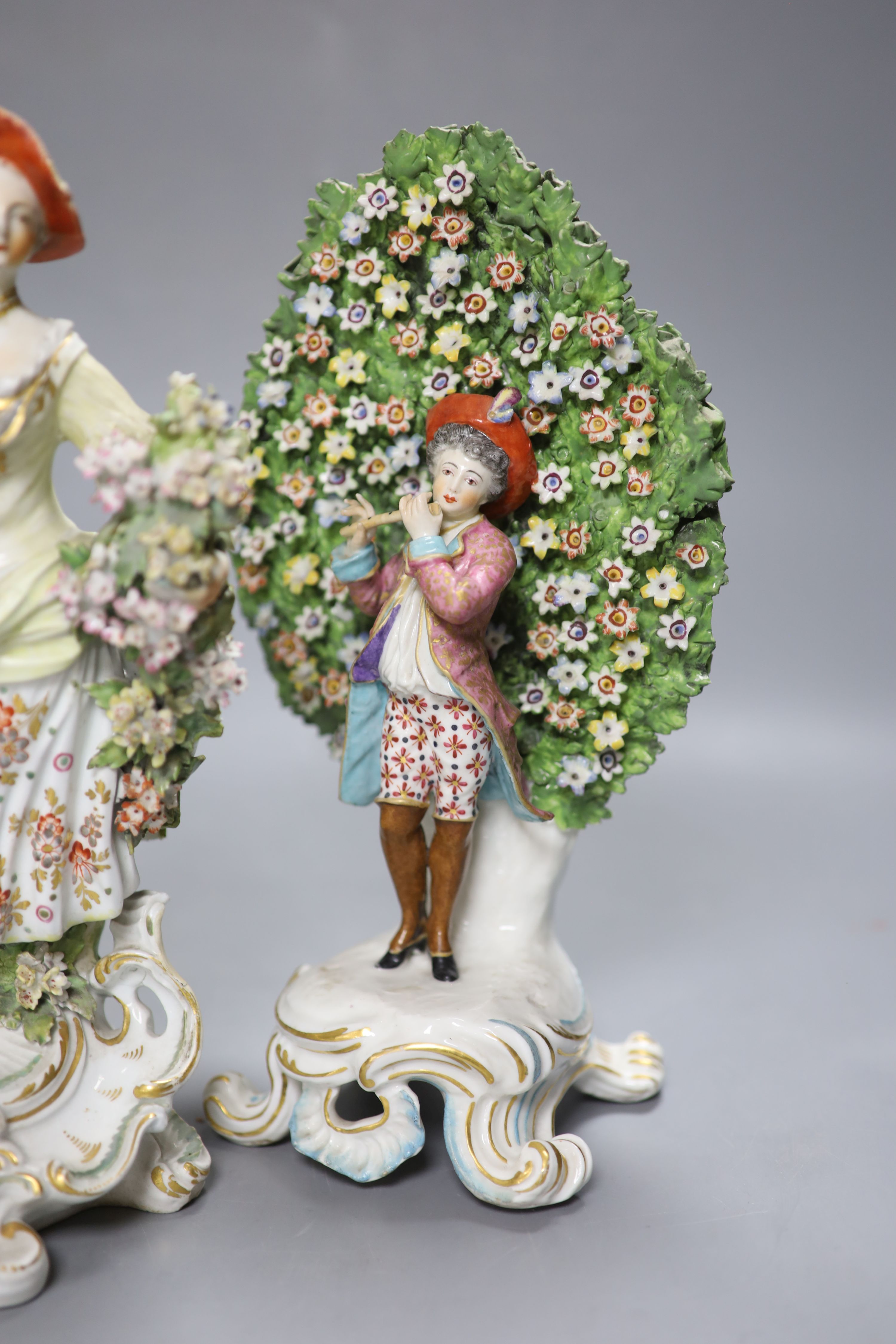 An 18th century Derby figure of a flower seller and a pair of French porcelain bocage groups, - Image 3 of 4