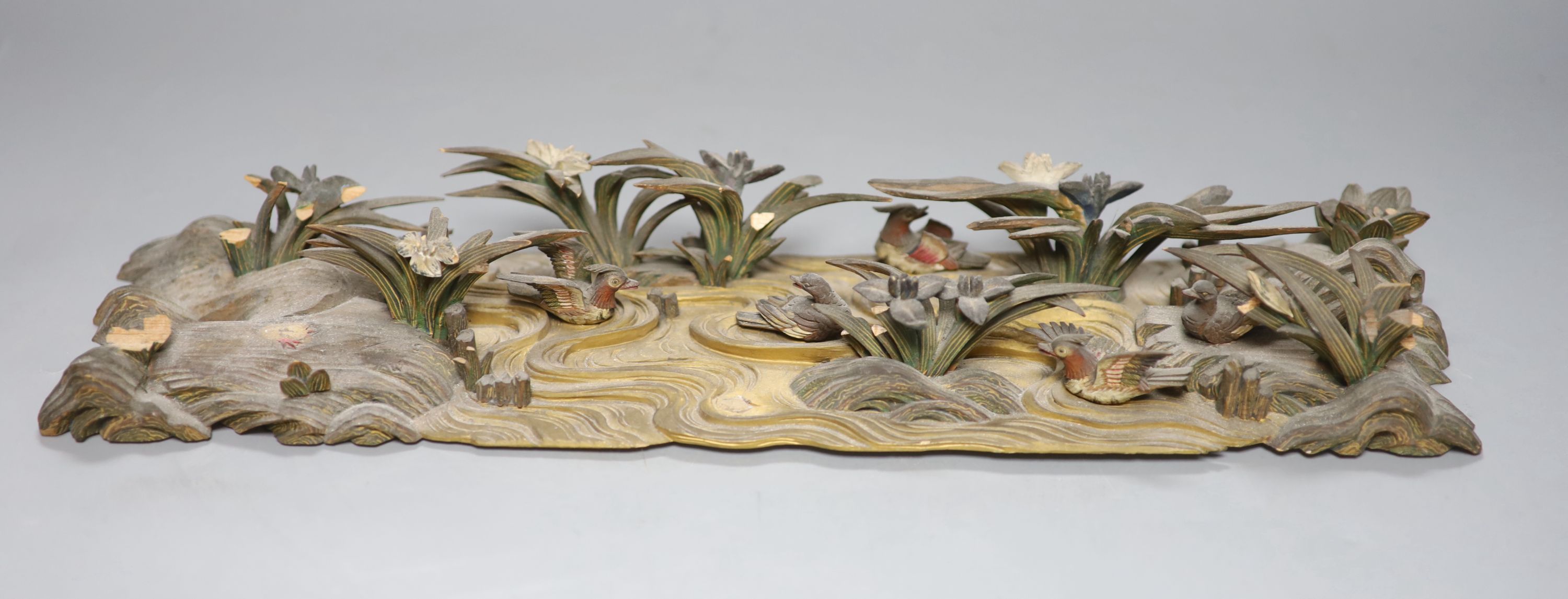 A Japanese carved and painted wood model of ducks on a pond, Meiji period, 40cm