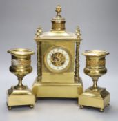 A late 19th century gilt brass three piece clock garniture, the clock with an eight day striking