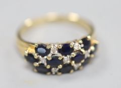 A modern 14ct gold, sapphire and diamond cluster half hoop dress ring, size Q, gross 4 grams.
