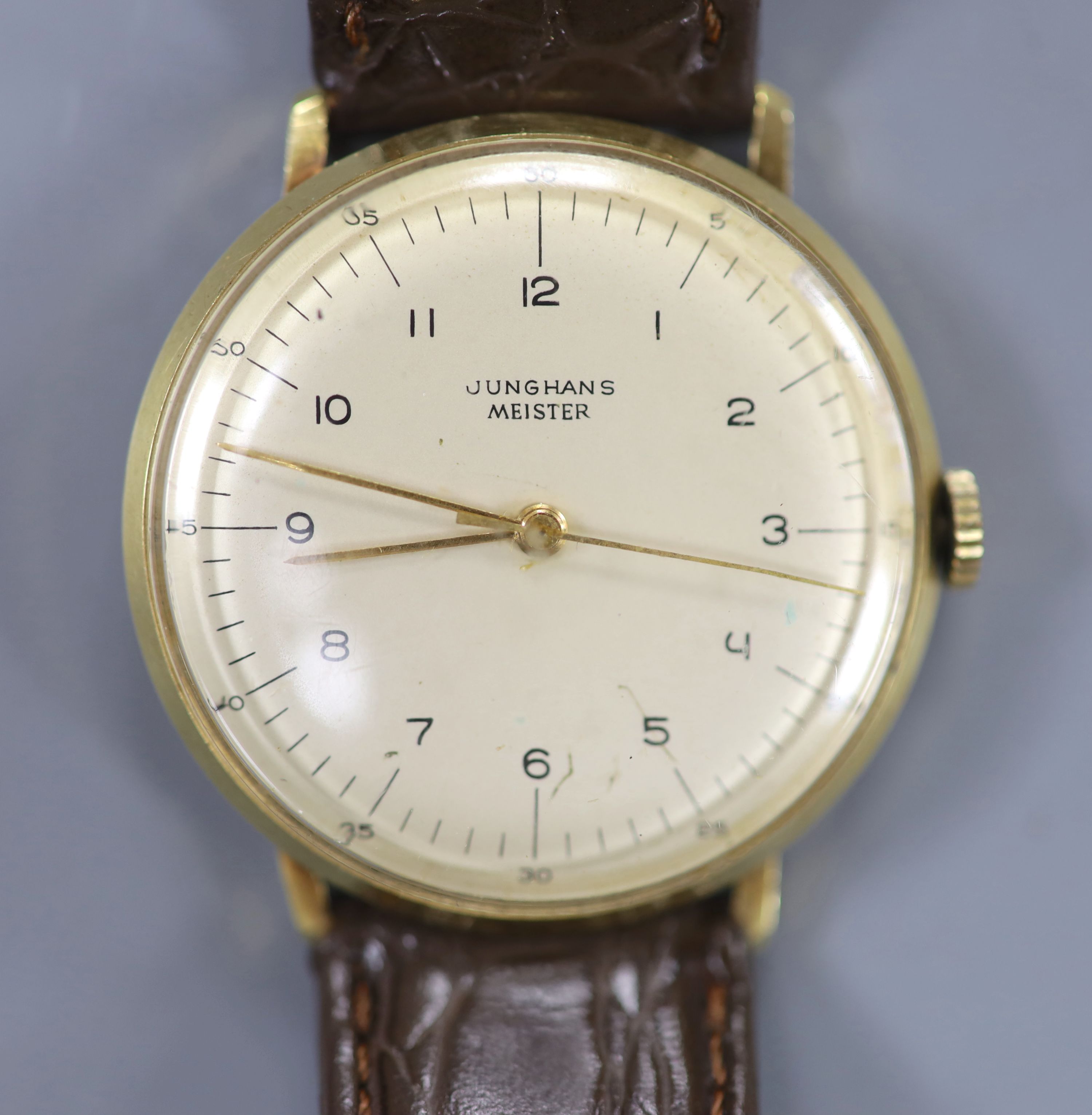 A gentleman's 14ct Junghans Meister manual wind wrist watch, on a associated leather strap and