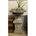 A reconstituted stone Campana garden urn and pedestal, diameter 80cm height 128cm