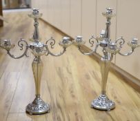 A pair of plated and glass four branch five light candelabra, height 68cm