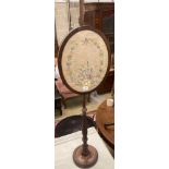 A Victorian mahogany pole screen, with oval tapestry banner, height 128cm