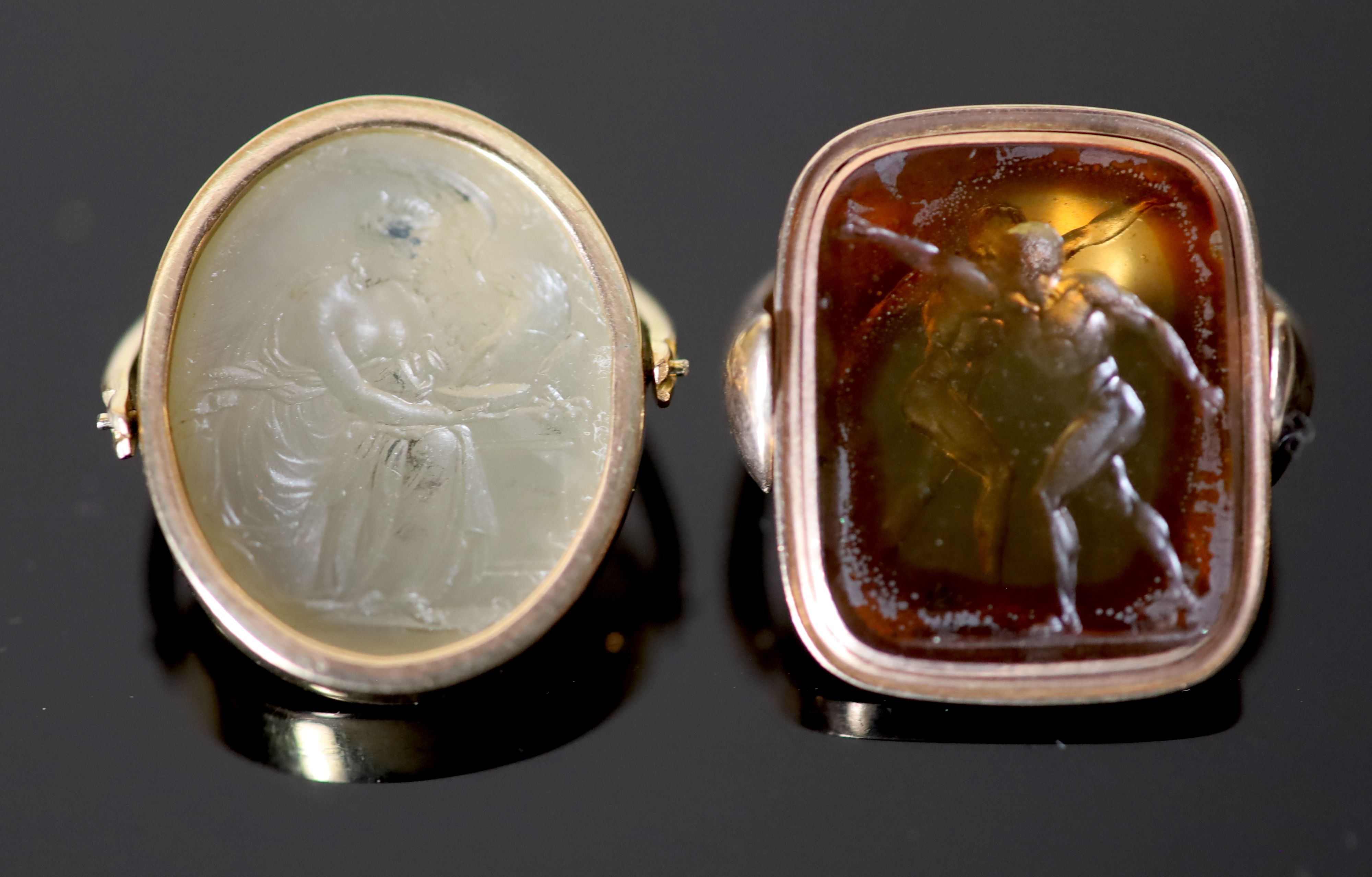 Two Victorian gold mounted intaglio set swivelling fobs, oval white agate carved with Hebe and the