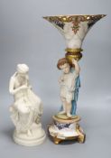 A Victorian Parian figure of a scantily clad fisher girl mending a net and a French trumpet shaped