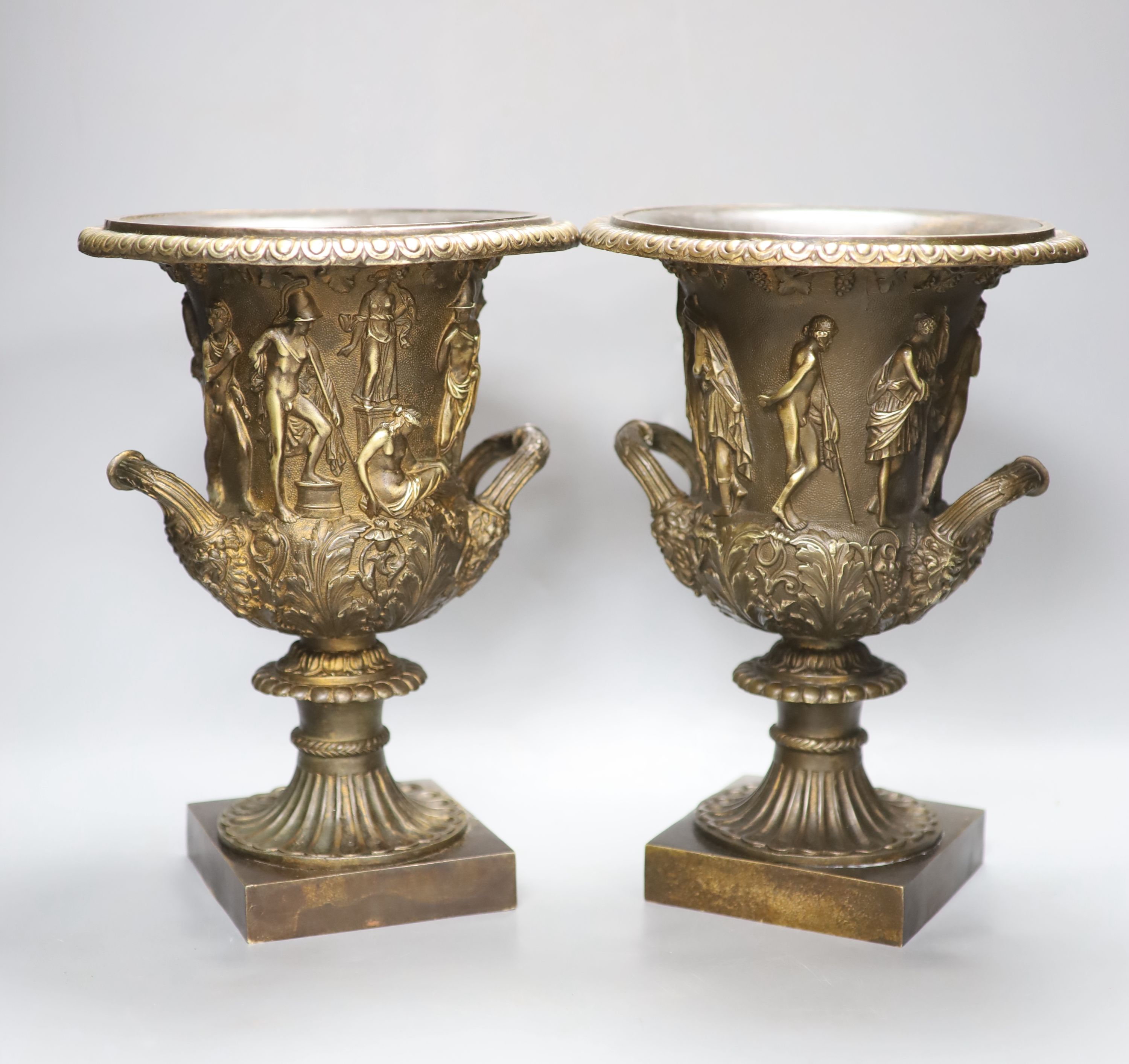 After the antique. A pair of bronze two handled Campana shaped urns, height 32cm