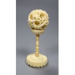 A carved Chinese ivory ball on stand, early 20th century, height 10.5cm