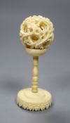 A carved Chinese ivory ball on stand, early 20th century, height 10.5cm