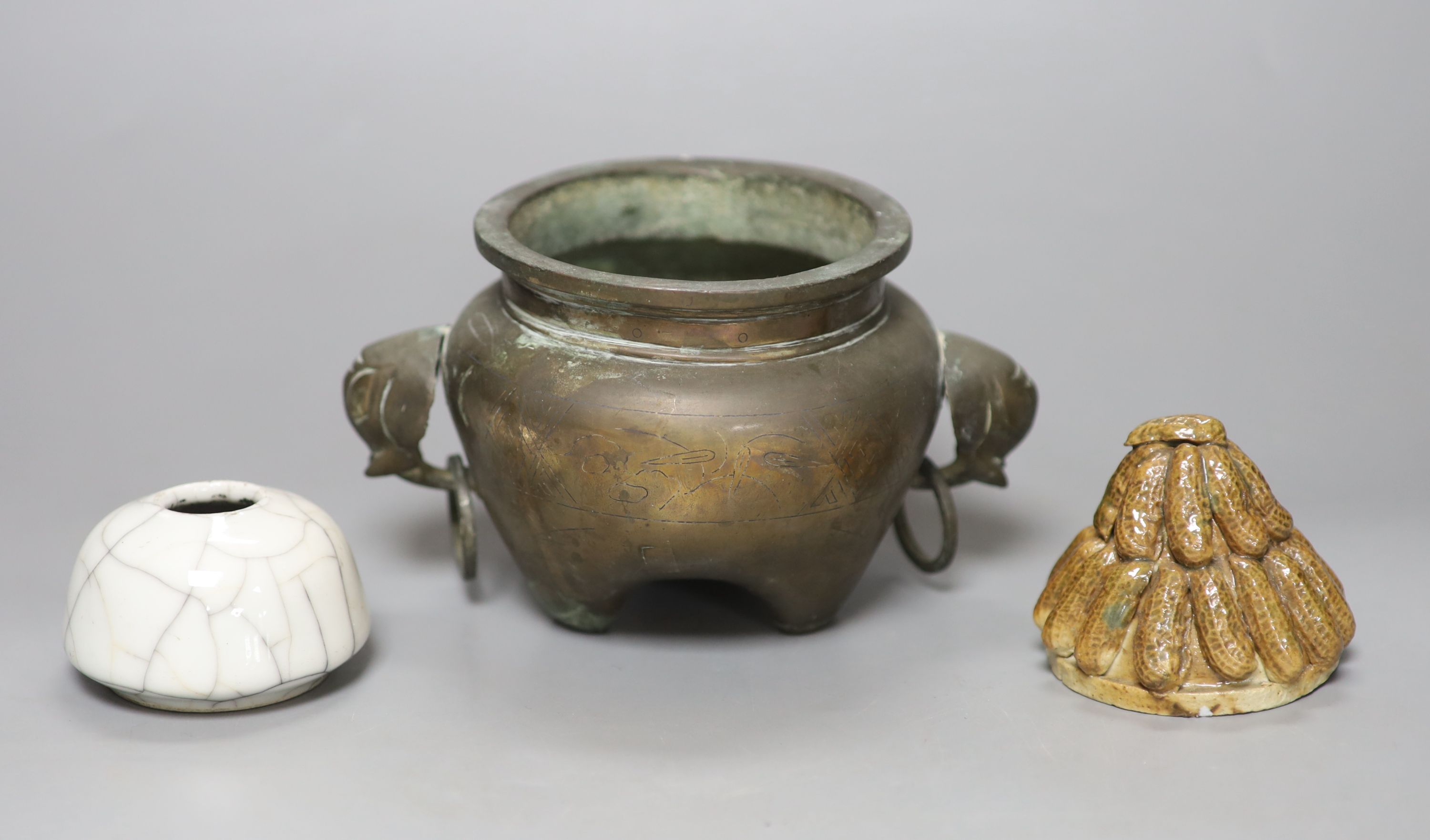 A Chinese bronze and silver inlaid tripod censer, c.1900, a stoneware cover and a crackleglaze