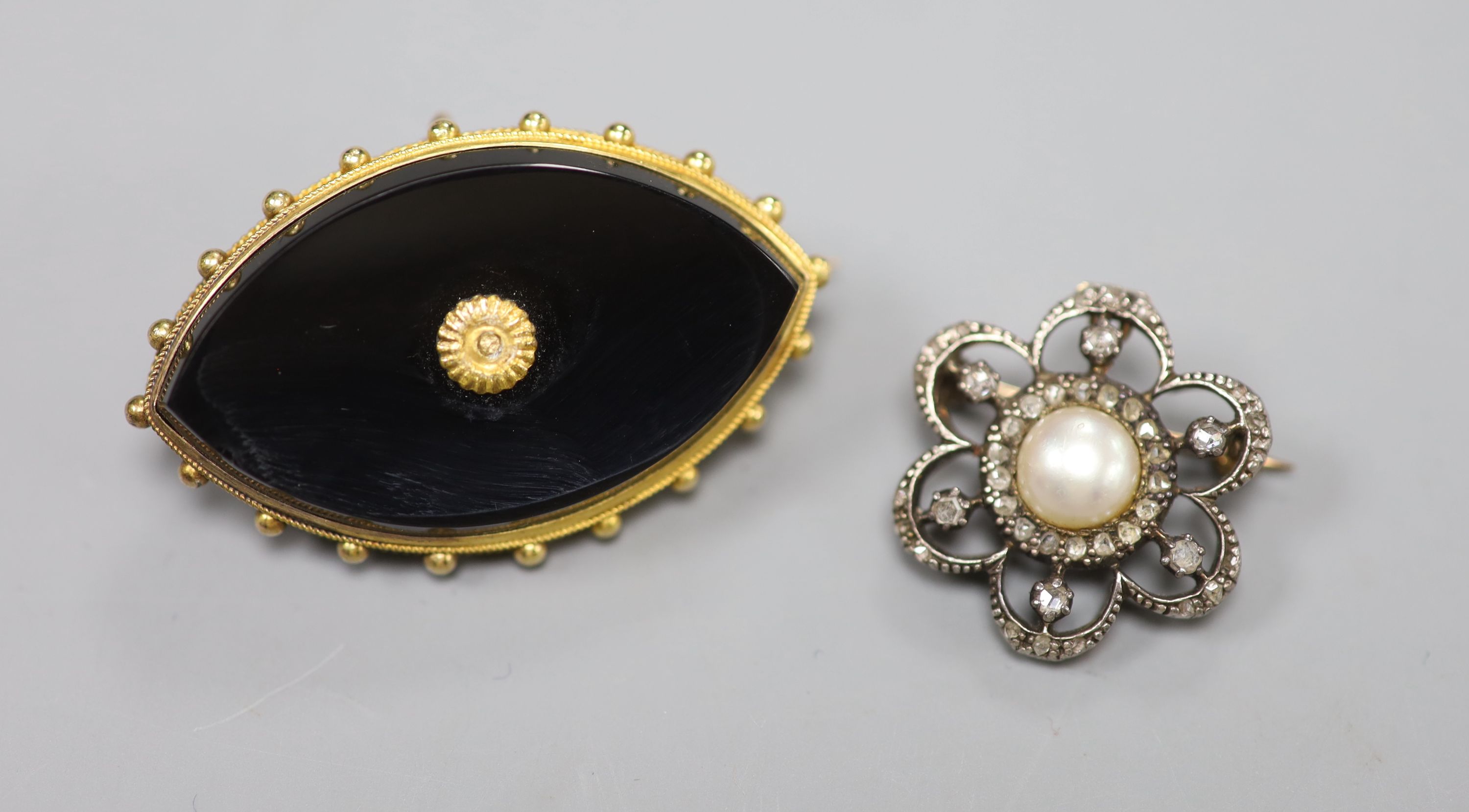 A Victorian yellow metal and onyx navette-shaped mourning brooch, 4cm, gross 10.9 grams and a rose