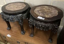 A pair of circular Chinese carved hardwood jardiniere stands, with rouge marble inset tops, 38cm