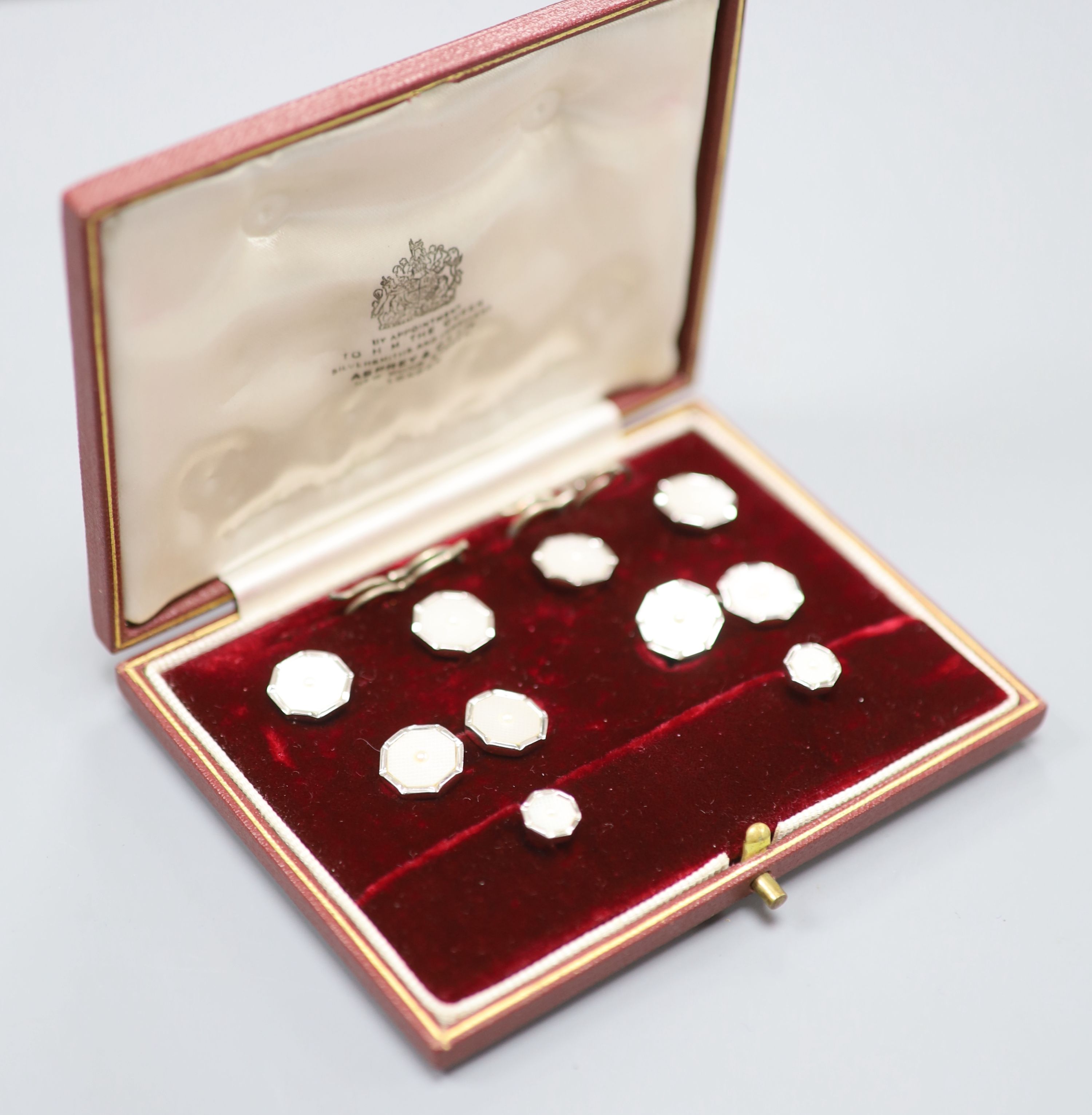 A gentlemen's 9ct white gold and mother of pearl dress set of octagonal form, cased, comprising a