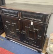 A Jacobean oak cupboard, fitted with a pair of doors, width 111cm, depth 60cm, height 102cm