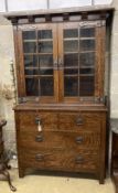 An early 20th century Arts and Crafts oak bookcase on chest, width 114cm, depth 48cm, height 208cm