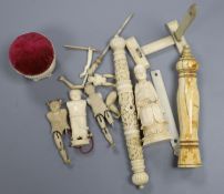 Three Chinese articulated ivory models of acrobats, two chess pieces, an ivory brush handle and
