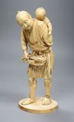 A large Japanese sectional ivory okimono of a fisherman and a boy, Meiji period, height 26cm