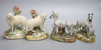 A pair of Staffordshire flatback Zebra and a pair of sheep spill vases