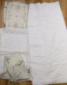 A large cutwork tablecloth, pillowcase plus a napkin and table mat set