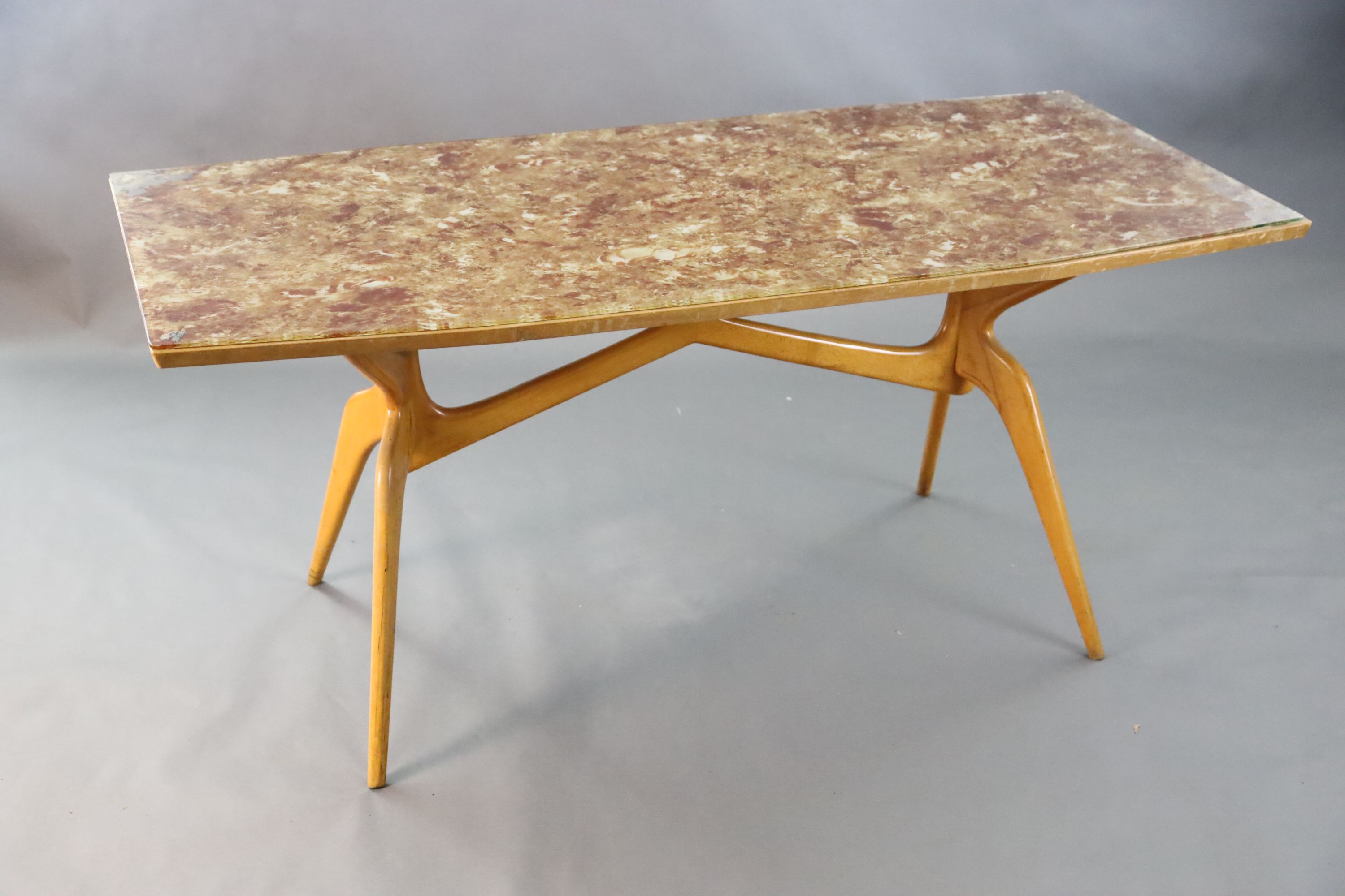A Carlo Graffi and Franco Compo glass topped beech dining table, of canted rectangular form, with