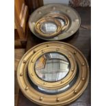 Five gilt and brass framed circular convex wall mirrors, largest 50cm diameter