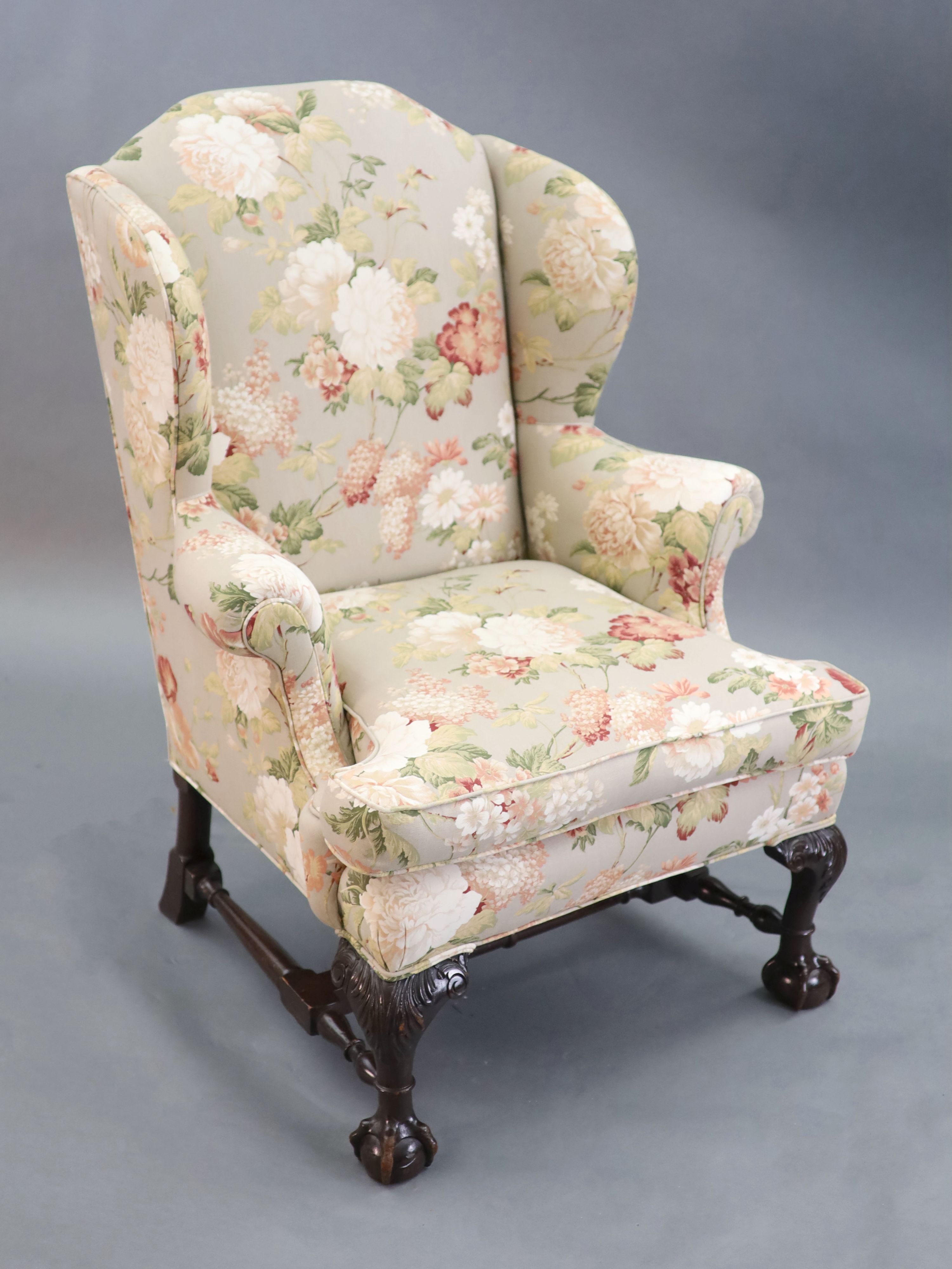 A Chippendale revival wing armchair together with a matching contemporary footstoolCONDITION: Late