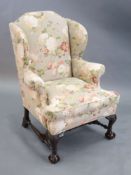 A Chippendale revival wing armchair together with a matching contemporary footstoolCONDITION: Late
