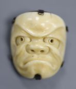 A 19th century Japanese carved ivory Noh mask netsuke mounted as a brooch, 4cm