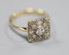 A 1940's yellow metal and diamond set square cluster ring, size M, gross 2.8 grams.CONDITION: Ols