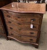 A George III style serpentine fronted, banded walnut chest, fitted four long drawers, width 70cm,