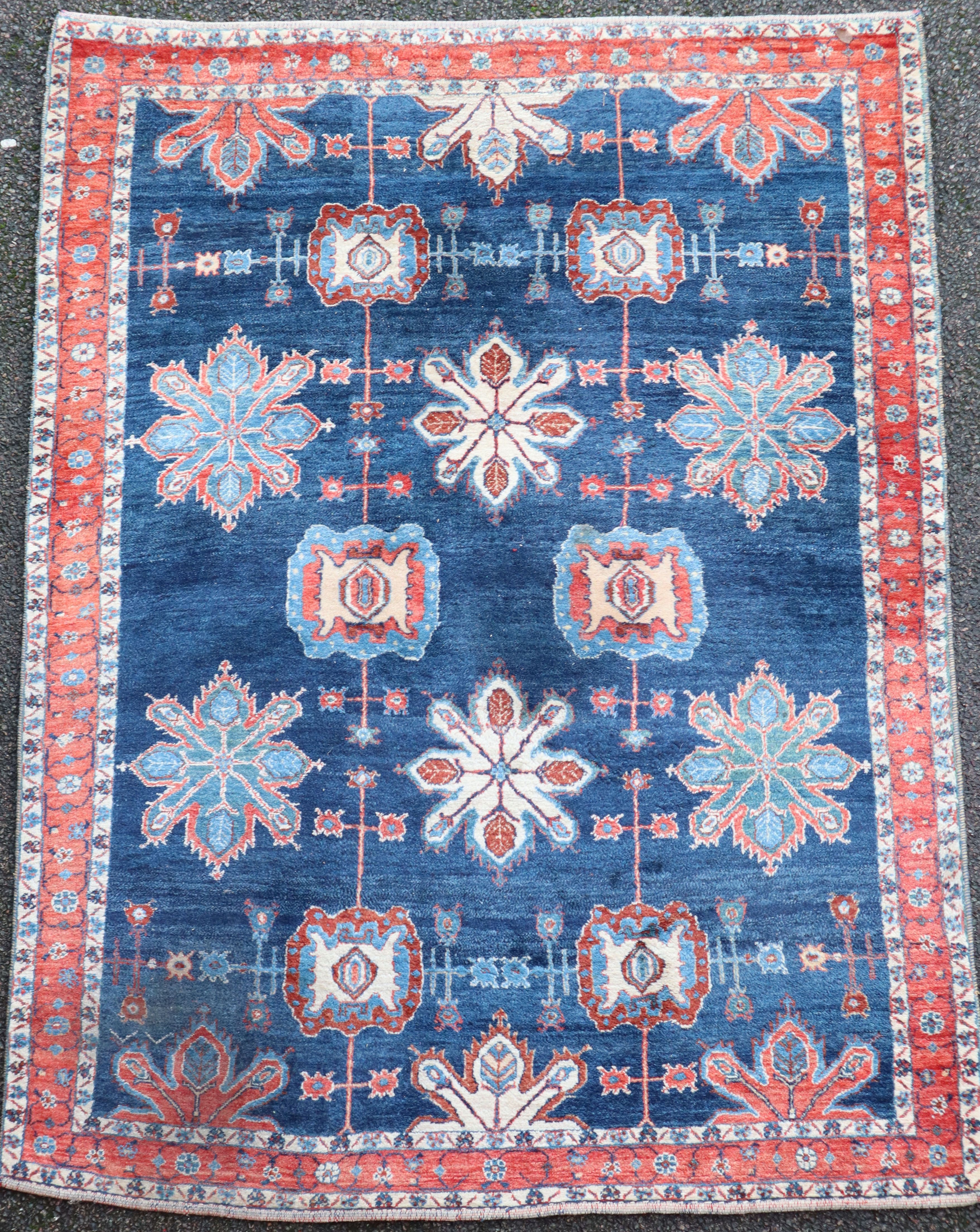 An Iranian Loribaft blue ground rug, with field of floral motifs and three row border, 225 x