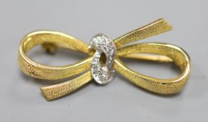 An 18ct gold and diamond bow brooch, 33mm, gross 5.4 grams.