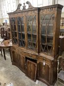 A George III style mahogany and walnut banded breakfront bookcase, with pierced broken swan neck