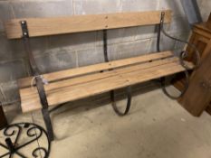 A wrought iron slatted wood garden bench, length 154cm, depth 54cm, height 83cm