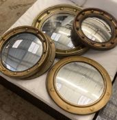 Six circular gilt and brass framed convex wall mirrors, largest 39cm diameter