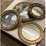 Six circular gilt and brass framed convex wall mirrors, largest 39cm diameter