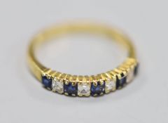 A modern 18ct gold, five stone sapphire and four stone diamond set half hoop ring, size M/N, gross