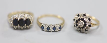 Three assorted modern 9ct gold and gem set dress rings, including one sapphire and diamond, gross