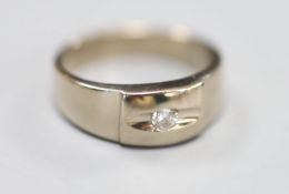 A modern white metal and gypsy set single stone diamond ring, size O, gross 8 grams.