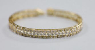 A modern pierced 9ct gold and diamond chip set line bracelet, length 18.5cm, gross 16.4 grams.