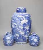 A tall 19th century Chinese blue and white lidded vase and a pair of lidded ginger jars, tallest