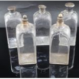 A part set of five early 19th century cut glass decanters, of square form with facetted shoulders,