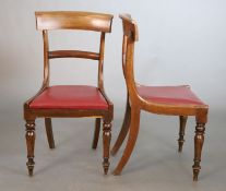 A set of five William IV mahogany dining chairs, with curved cresting rails and spars and red