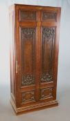 A late 19th century French oak hall cupboard, the single door with six panels inset with Régence